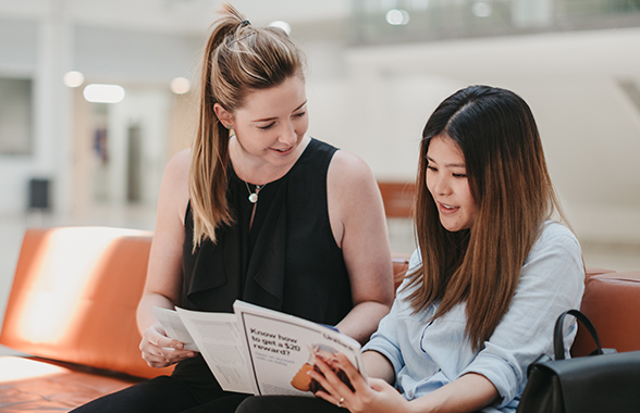 UWA Student receiving assistance from staff member sitting on sofa 